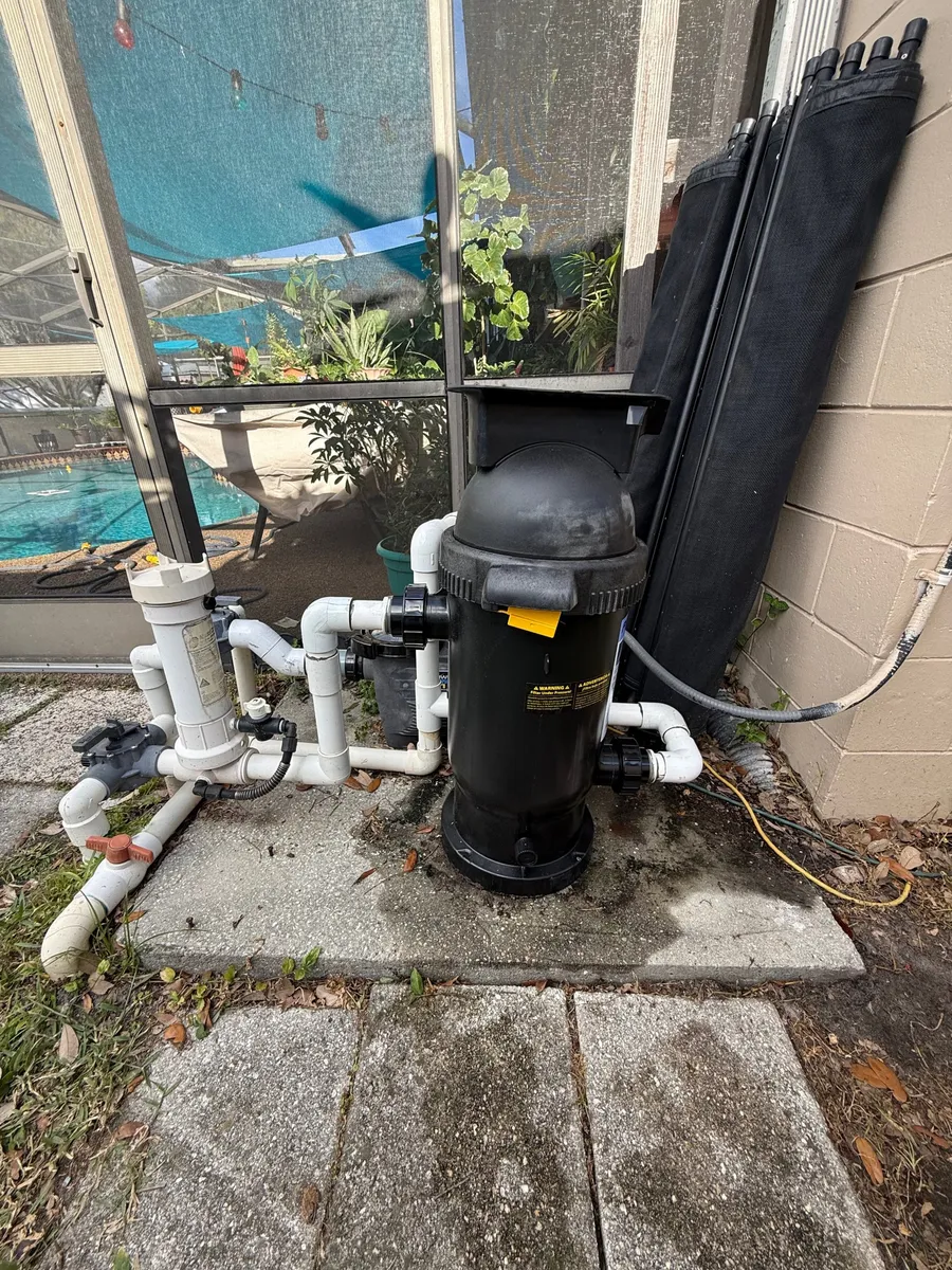 Cartridge filter, chlorinator and plumbing at a pool equipment pad
